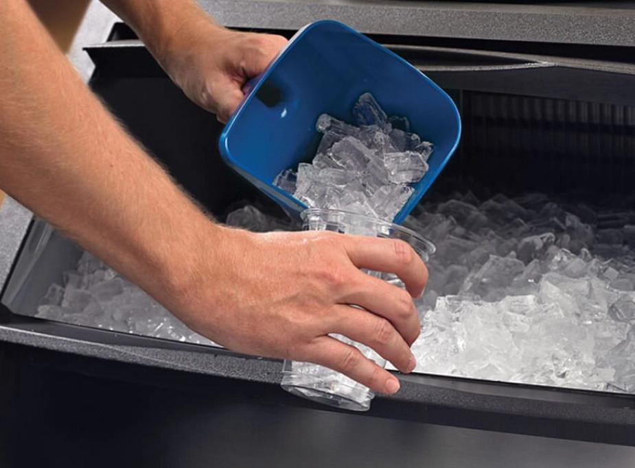 Commercial ice machine repair technician servicing a commercial ice maker in central Arkansas